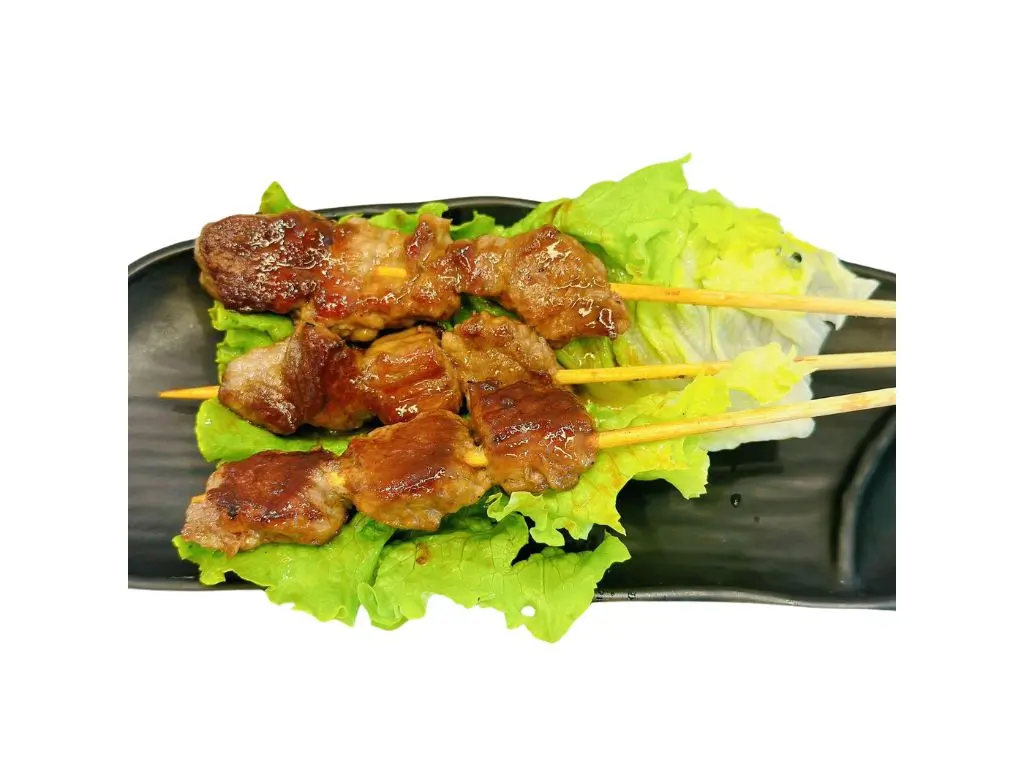 Grilled chicken skewers on lettuce, glazed with savory sauce at Sushi Naru Pho, a Asian Fusion Restaurant in Charlotte