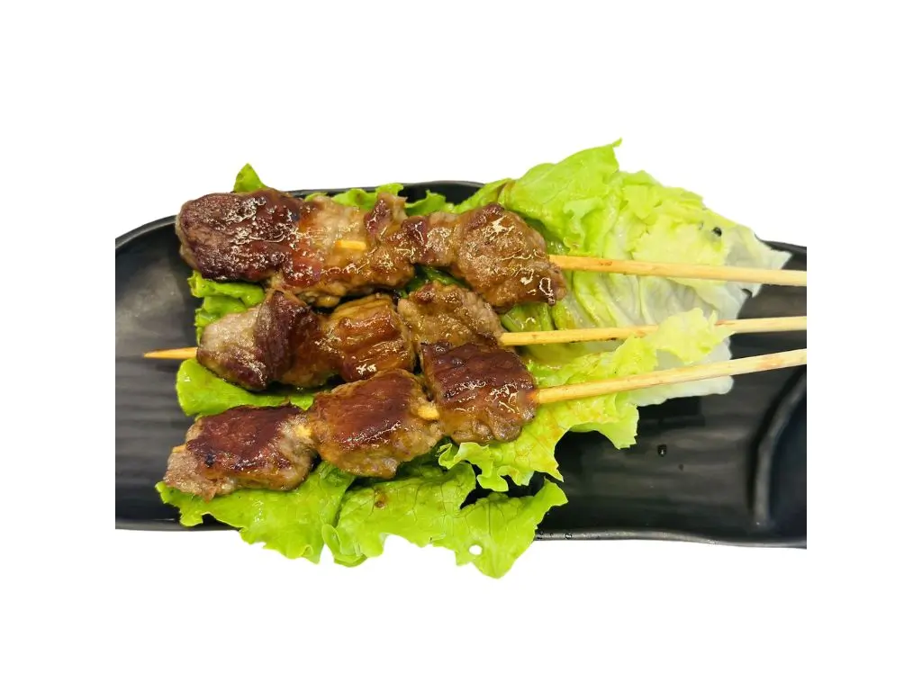 Grilled beef skewers on lettuce, glazed with savory sauce at Sushi Naru Pho, a Asian Fusion Restaurant in Charlotte