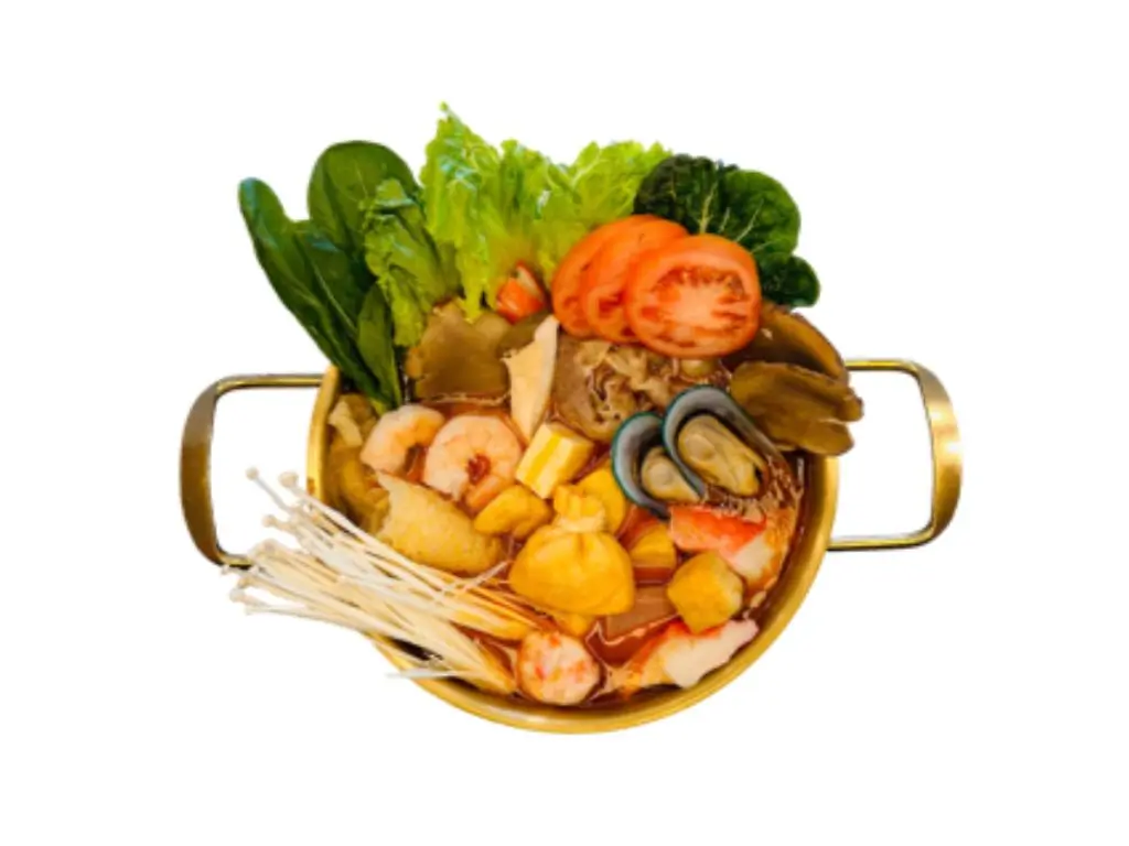 Tomato - flavored hot pot base with ingredients like shrimp, mushrooms, tomatoes, and vegetables at Sushi Naru Pho, a Asian Fusion Restaurant in Charlotte