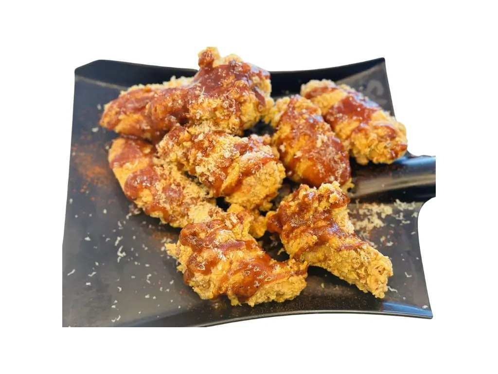 Crispy chicken wings glazed with sweet - spicy sauce and sprinkled with cheese at Sushi Naru Pho, a Asian Fusion Restaurant in Charlotte